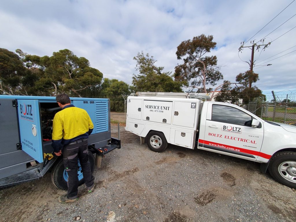 Boltz Electrical van and electrician checking a generator